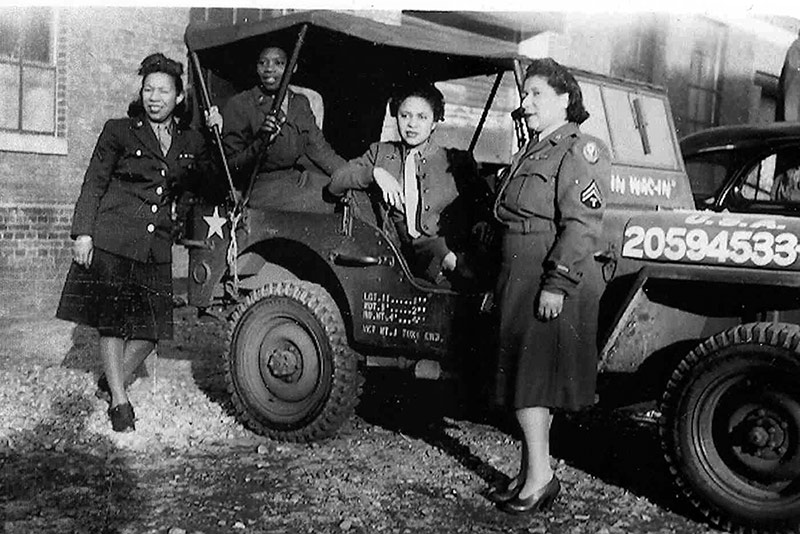 Four members of the 6888th Postal Battalion in Europe with an Army Jeep.